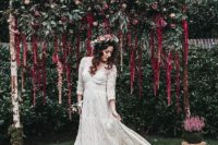 02 The bride was wearing a boho lace maxi dress with long sleeves and a V-neckline, a fresh floral crown