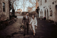 02 The bride was wearing a long sleeve boho lace wedding gown with a plunging neckline, fringe and a faux fur wrap