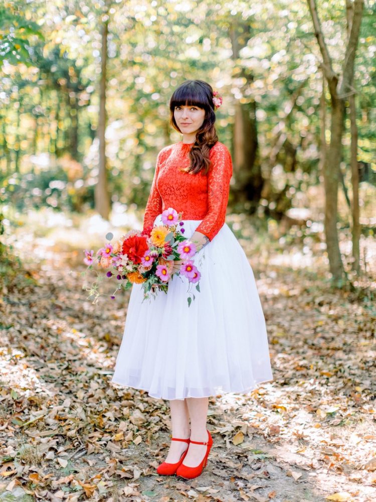 a bright bridal look with a red lace top with long sleeves and matching  shoes plus a tulle white skirt