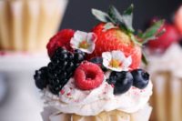 02 vegan vanilla cupcakes with fresh berries and edible flowers on top are a vegan take on a classic dessert