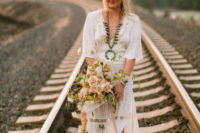 04 The bride was wearing a boho wedding dress with long sleeves, a V-neckline and a side slit
