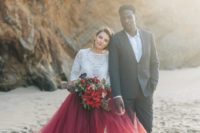 04 a bold color block bridal outfit with a white boho lace top with long sleeves and a burgundy tulle skirt