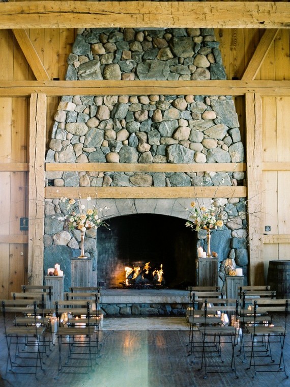 The ceremony space was styled around a large fireplace, there were faceted candle holders and some dimensional floral arrangements