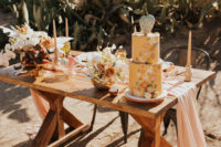 06 The wedding tablescape was a peachy and blush one, with a long table runner, lush florals and colored glasses