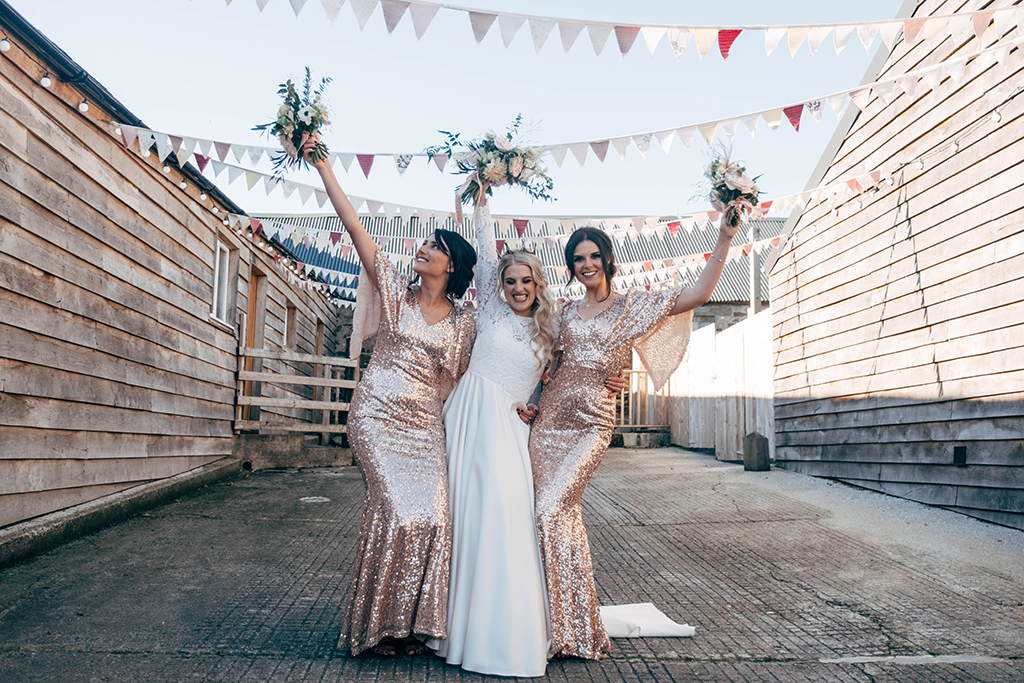 The bridesmaids were wearing rose gold sequin maxi dresses with wide sleeves