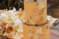 a yellow wedding cake with flowers