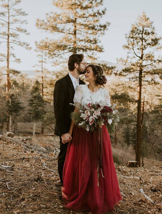 a chic bridal outfit with a white lace top and short sleeves plus a burgundy maxi skirt