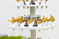 08 a creative French fry stand with ketchup and some fresh veggies and French fries in paper cones