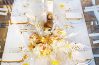 11 The reception table was also styled with gold and mustard touches, with a chic centerpiece and white candles