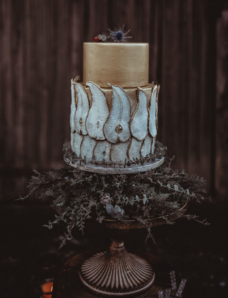 The wedding cake was a gilded one, with thistles on top and pears