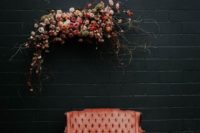 11 a chic photo booth with a refined coral sofa, a lush floral installation and blooms and petals