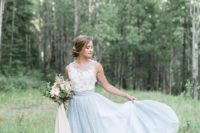 11 a tender bridal look with a white lace sleeveless top and a powder blue skirt with a train
