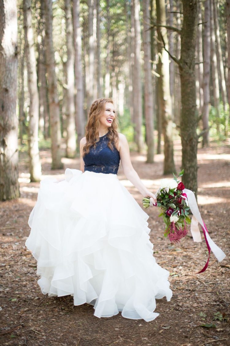 a chic wedding outfit with a navy lace halter neckline top and a ruffle full skirt