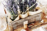 13 a cozy Provence-inspired wedding centerpiece of a wooden crate and lavender in jars