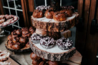 a rustic-inspired wedding dessert bar with wood slices