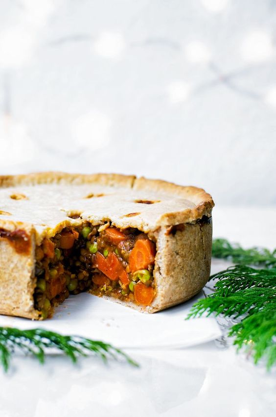 a vegan holiday hot pie with hot water pastry, carrots, onions, paprika, peppers and lentils