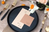 16 a chic color block wedding setting with blush and dusty pink cards, a black charger and black and gold cutlery