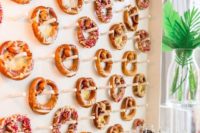 18 a pretzel wall with dips in glasses is a very trendy and bold idea to go for, your station will be unique