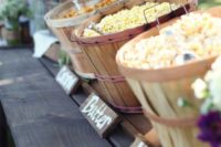 20 a rustic popcorn bar done with wooden baskets and wooden signs is a very cozy idea