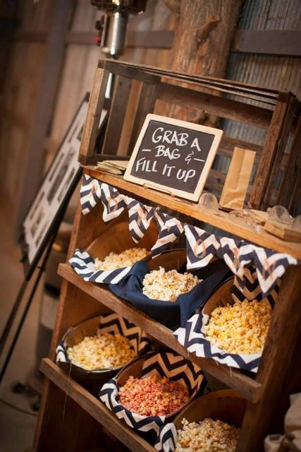 a small popcorn bar with chevron covered baskets is a cool idea of a late night snack