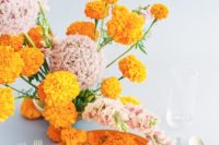 21 marigold and soft pink against a pale blue background is an icredible combo for a color-loving couple