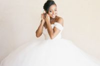 22 a statement off the shoulder wedding ballgown with a draped bodice and a super full skirt