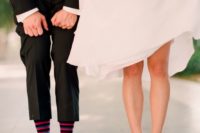 22 the bride showing off her bright heels and the groom showing off his funny colorful socks