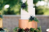 23 a color block wedding cake with a copper and white layers plus lush tropical greenery