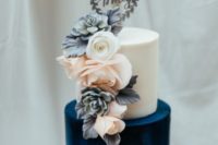 24 a color block wedding cake with a white and navy tier and sugar blooms for decor