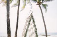 24 a creative beach wedding ceremony arbor saped as a boat and decorated as greenery and white blooms