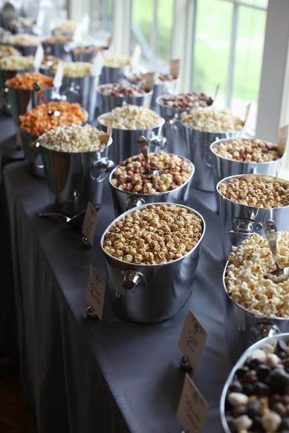 an elegant popcorn bar with silver tubs and labels is a fit for any wedding, the tubs are very elegant