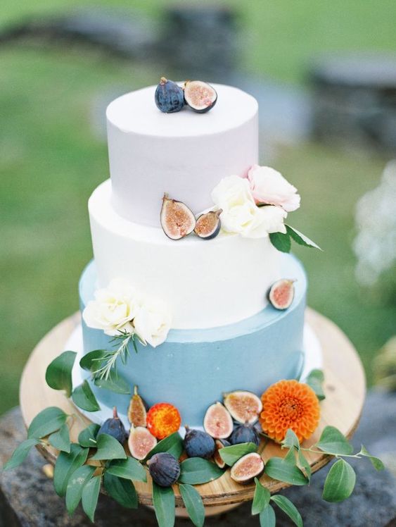 a color block wedding cake with whitetiers and a powder blue one plus fresh figs and blooms