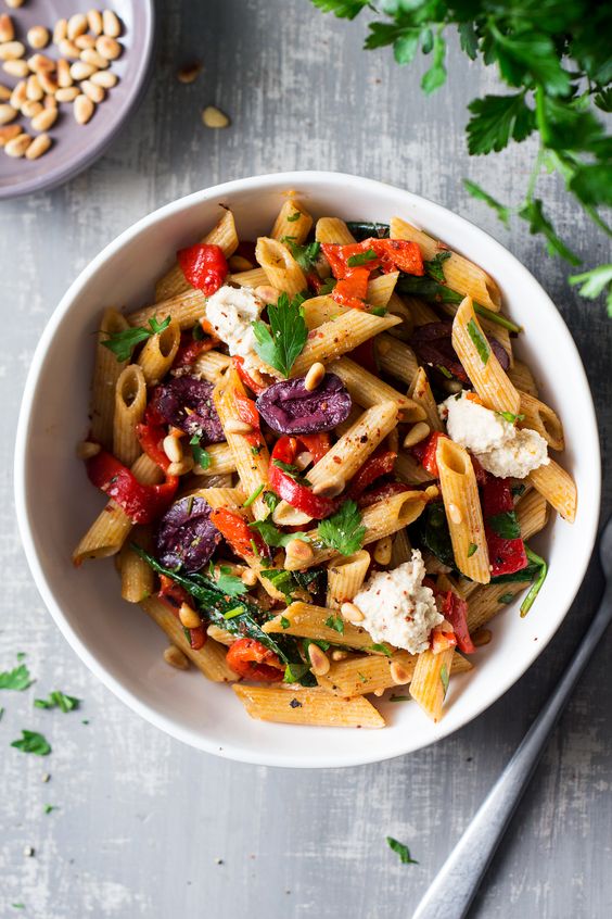 vegan red pepper pasta with spinach, garlic, olives, pine nuts and of course peppers