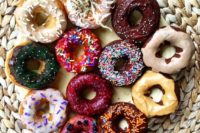 27 vegan donuts with colorful glaze and sprinkles are colorful, fun and whimsy for a vegan wedding