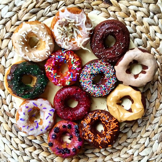 vegan donuts with colorful glaze and sprinkles are colorful, fun and whimsy for a vegan wedding