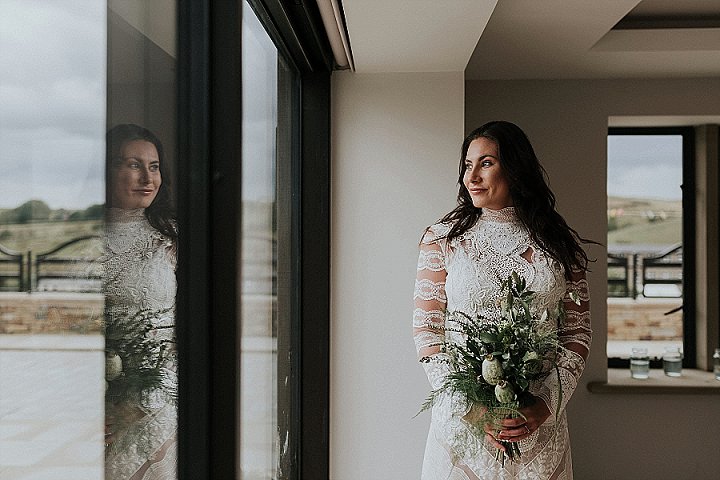 The bride was wearign a lace two-piece wedding dress with a high neckline and long sleeves