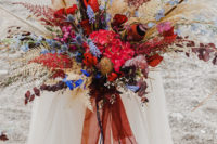 02 The wedding bouquet was super bright, red, blue, mustard, with lots of texture and ribbons