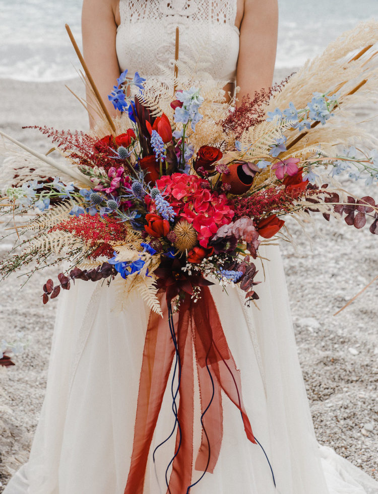 The wedding bouquet was super bright, red, blue, mustard, with lots of texture and ribbons