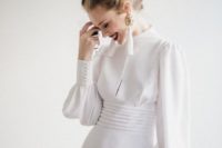03 a modern take on a vintage wedding dress – a plain turtleneck Victorian-inspired wedding gown with long sleeves and tassel earrings