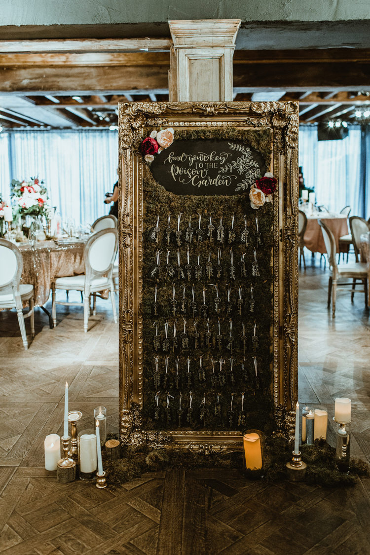 The wedding seating chart was done with moss, a vintage refined frame and blooms and candles