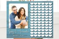 04 a stylish wedding guest book of a blue wooden sign, a large couple photo and lots of wooden hearts attached
