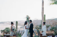 05 The ceremony space was a boho one, with mismatching chairs, a triangle arch, cacti and a gorgeous beach view