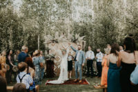 06 The wedding backdrop was done with catchy wooden chevron patterns and with blooms and pampas grass on top