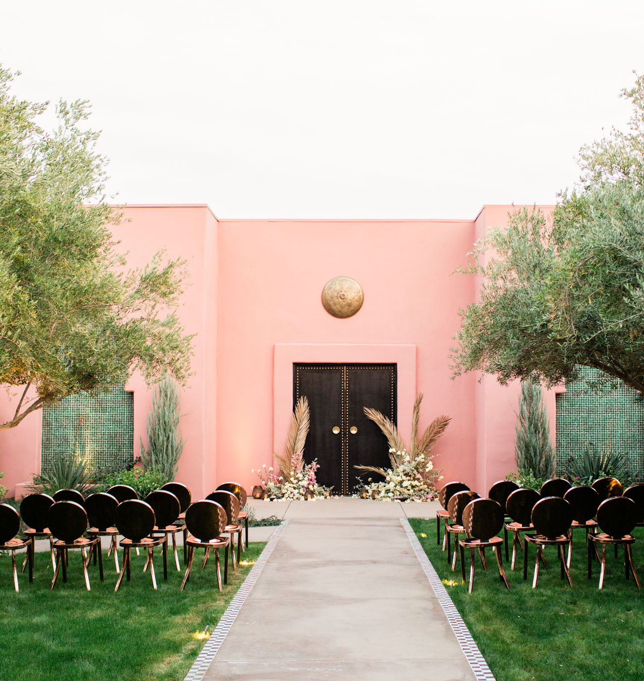 The wedding ceremony space was done in pink, black and gold and with black and gold chairs