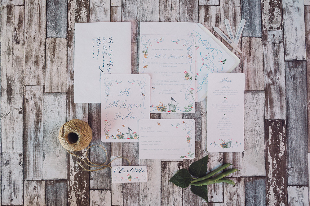 The wedding stationery was done with some painted blooms and watering cans