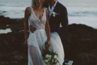 06 a bold modern wedding dress with a lace bodysuit with no sleeves and a sheer skirt plus a train