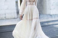 06 a chic and unusual wedding gown with a lace top with a turtleneck, puff sleeeves and lace inserts plus an airy skirt with a train