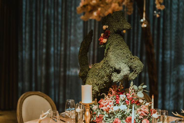 Sme centerpieces were done with lush florals and moss animal figurines for an enchanted forest feel