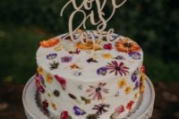07 a beautiful wedding cake with edible fwildflowers in the icing and a calligraphy cake topper