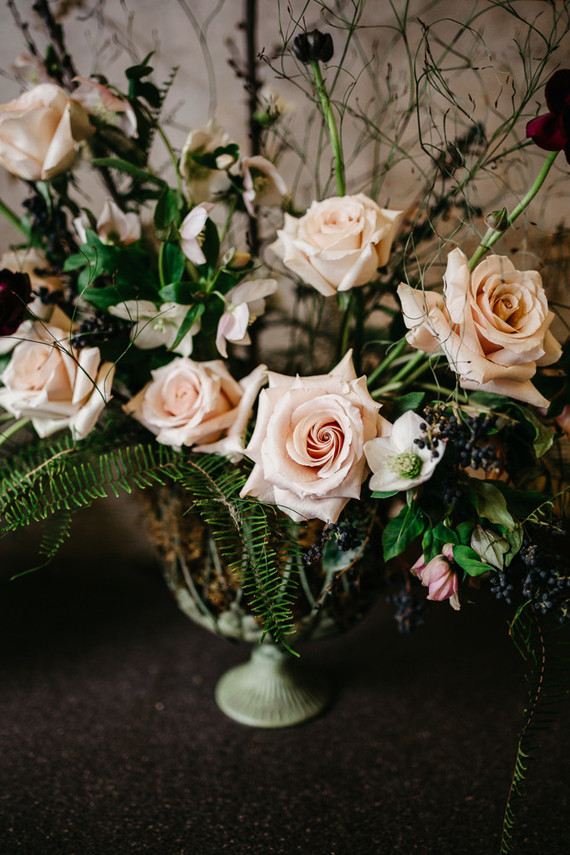 The wedding centerpiece was done in blush and black with much greenery